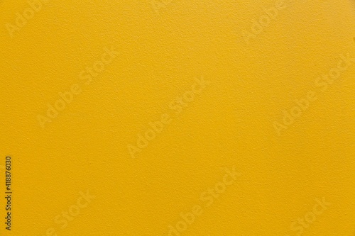Vintage yellow painted concrete wall texture and background seamless
