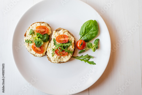 egg cheese ham dip, spread on open finger food sandwich with salad, tomato vegetables 