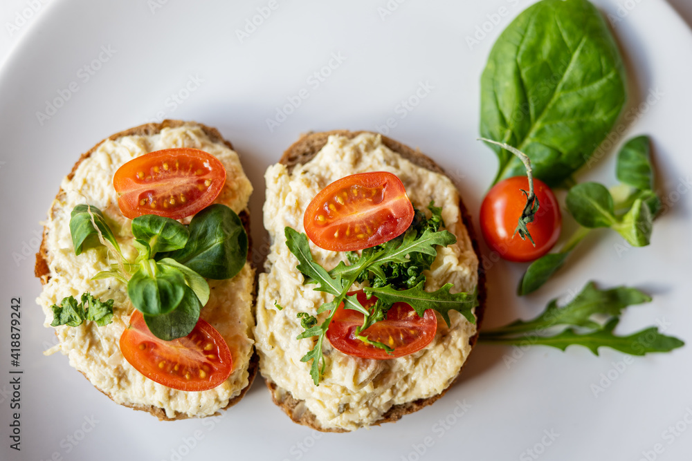 egg cheese ham dip, spread on open finger food sandwich with salad, tomato vegetables egg cheese ham dip, spread on open finger food sandwich with salad, tomato vegetables