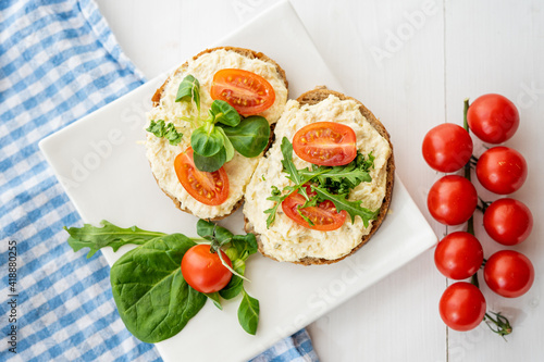 egg cheese ham dip, spread on open finger food sandwich with salad, tomato vegetables 