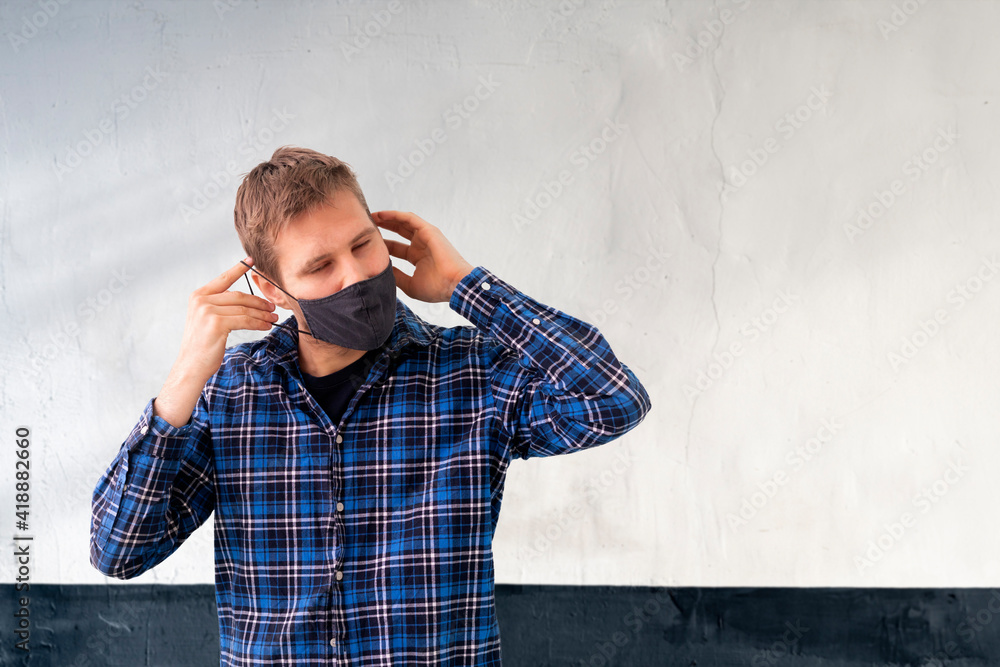 young male person wear the black textile mask to protect from the covid-19 virus, casual lifestyle clothes young male person wear the black textile mask to protect from the covid-19 virus, casual lifestyle clothes