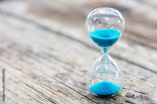 Blue hourglass background concept for deadline, urgency and countdown