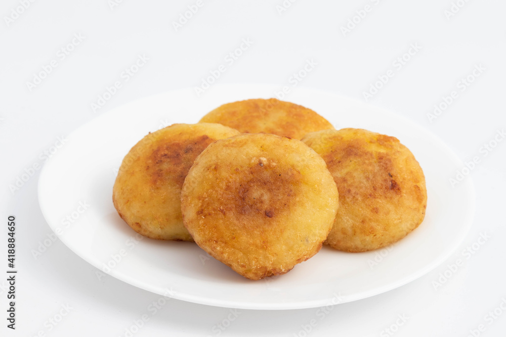 Aloo Tikki Also Known As Alu Ki Tikkia Is Seasoned Boiled Mashed Potato Cutlet Or Patties Used In Various Indian Street Food Masala Chaat Snacks. Isolated On White Background With Copy Space Aloo Tikki Also Known As Alu Ki Tikkia Is Seasoned Boiled Mashed Potato Cutlet Or Patties Used In Various Indian Street Food Masala Chaat Snacks. Isolated On White Background With Copy Space