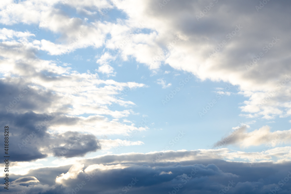 Fototapeta premium Sky with dark clouds and a skylight in the center, soft focus