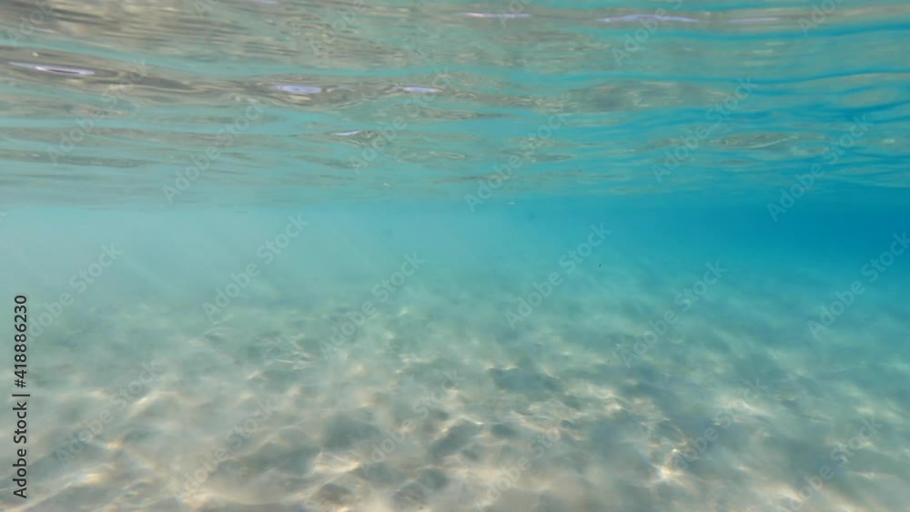 Underwater video of tropical exotic turquoise sandy sea bed as seen at summer Underwater video of tropical exotic turquoise sandy sea bed as seen at summer