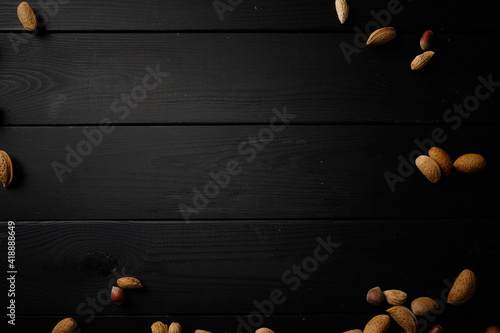 nuts on the wooden black background