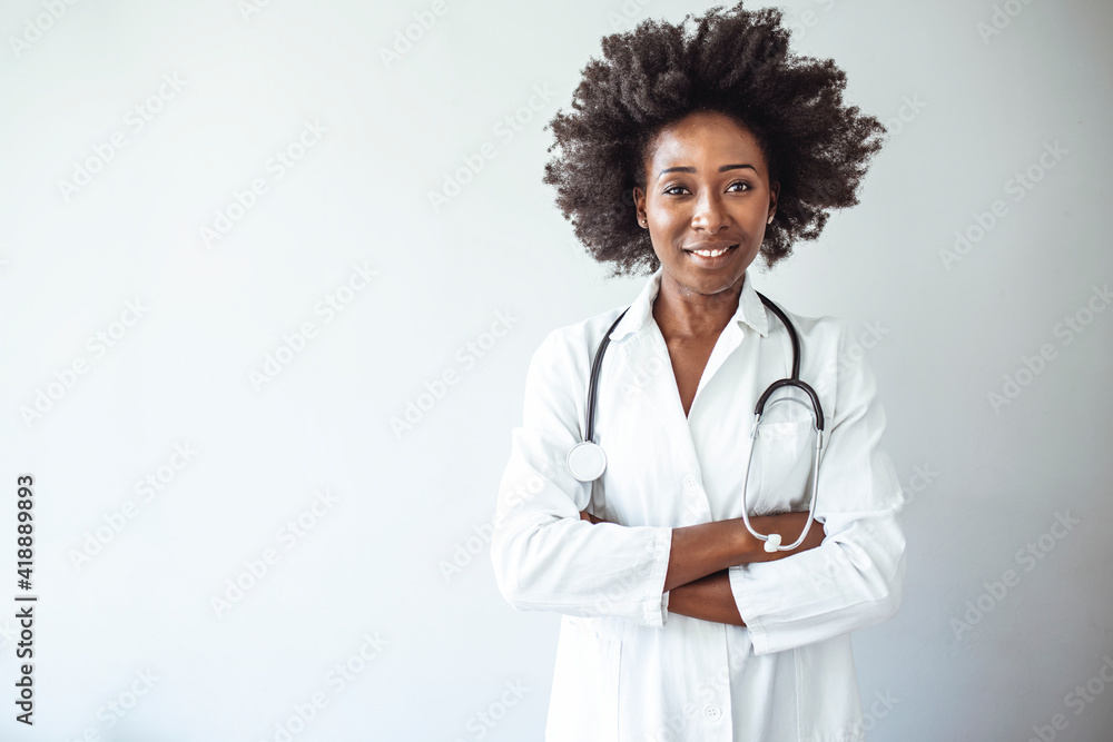 Portrait of female African American doctor standing in her office at clinic. Portrait of a confident doctor working at a hospital. Doctor holding digital tablet at meeting room Portrait of female African American doctor standing in her office at clinic. Portrait of a confident doctor working at a hospital. Doctor holding digital tablet at meeting room
