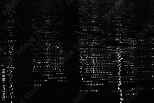 Foto Abstract black and white city lights refection in water during night depicting t