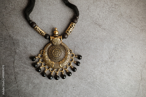 Fotografie Indian traditional gold necklace with black beads