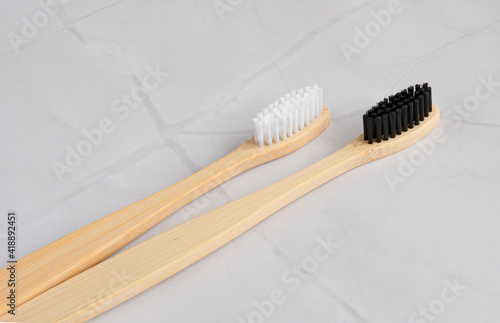 Two bamboo toothbrushes on a white marble background in the bathroom. The concept of recyclable and natural recycling of the toothbrush. Oral cavity care. top view. copy space for text
