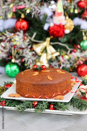 Indian Christmas celebration serving homemade Christmas plum cake India Kerala. Fruitcake made of dried fruit, nuts, spices , rum for New Year party, Easter, Christmas Eve