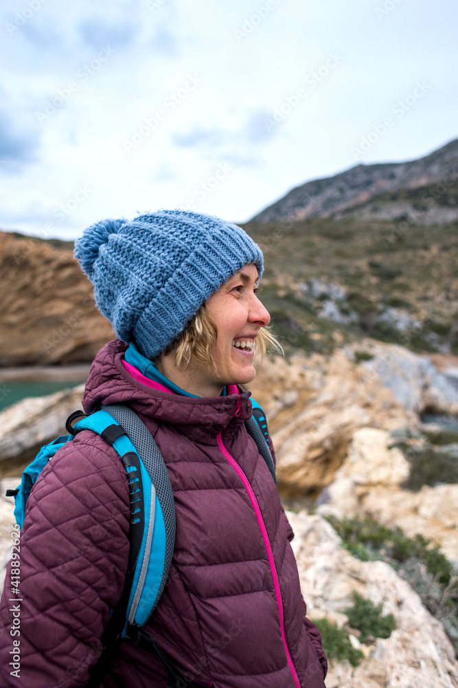 Portrait of a smiling girl in a knitted hat while walking along the sea coast Portrait of a smiling girl in a knitted hat while walking along the sea coast