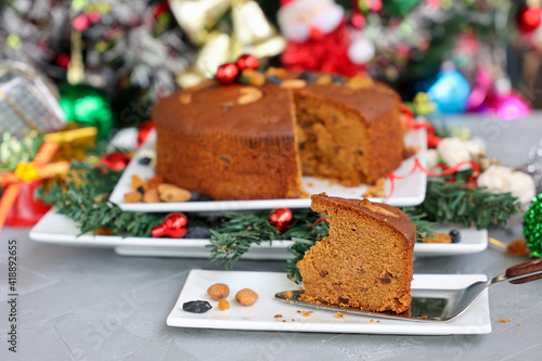 Indian Christmas celebration serving homemade Christmas plum cake India Kerala. Fruitcake made of dried fruit, nuts, spices , rum for New Year party, Easter, Christmas Eve
