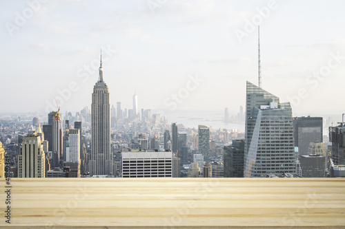 Empty tabletop made of wooden dies with New York city view at daytime on background, template