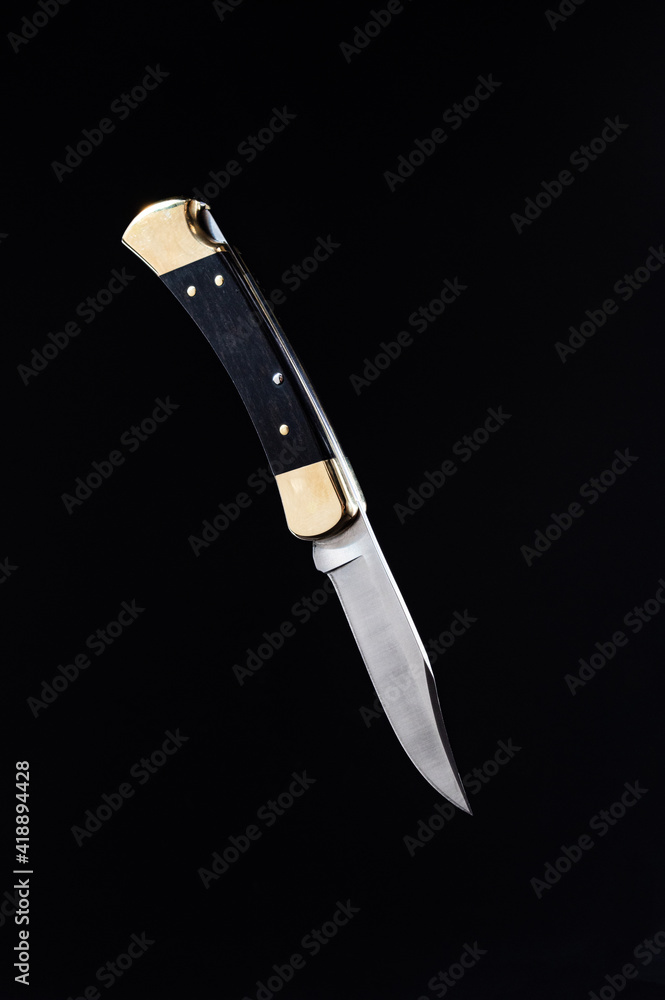 Hunting folding knife with gold accents. Classic hunting knife.