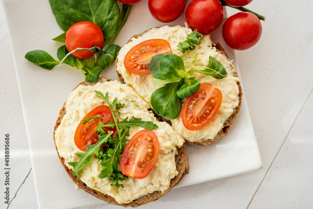 egg cheese ham dip, spread on open finger food sandwich with salad, tomato vegetables egg cheese ham dip, spread on open finger food sandwich with salad, tomato vegetables