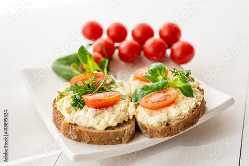egg cheese ham dip, spread on open finger food sandwich with salad, tomato vegetables 