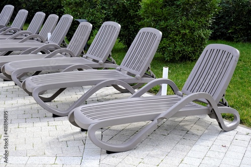 a row of grey sun loungers for sunbathing