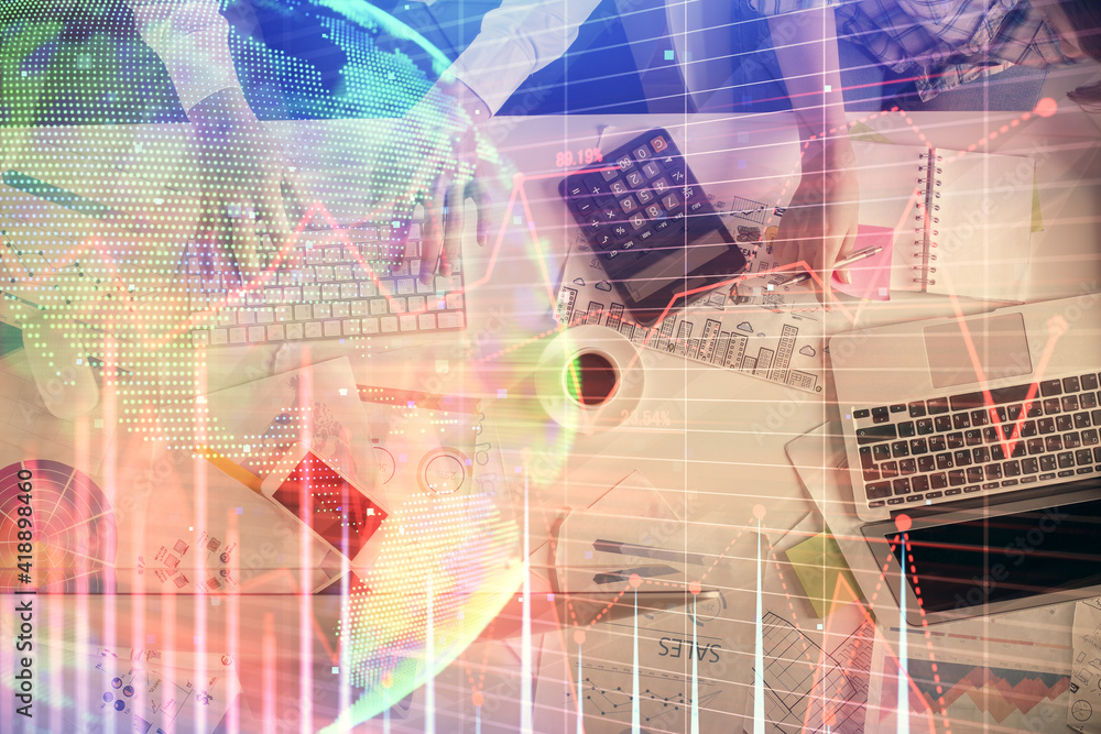 Obraz premium Double exposure of man and woman working together and financial chart hologram drawing. market analysis concept. Computer background. Top View.