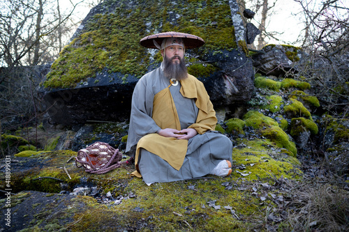Fotografi European man with beard meditates in traditional, Japanese, Shugendo outfit outd