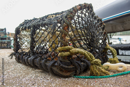 Close up of a single lobster pot, drying on the harbour