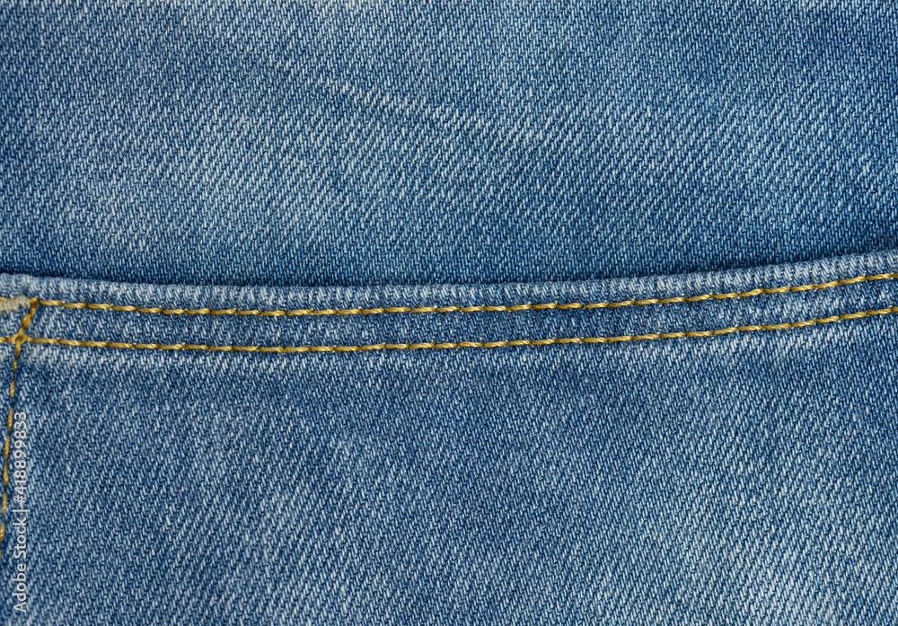 sewing line from brown threads on blue jeans sewing line from brown threads on blue jeans