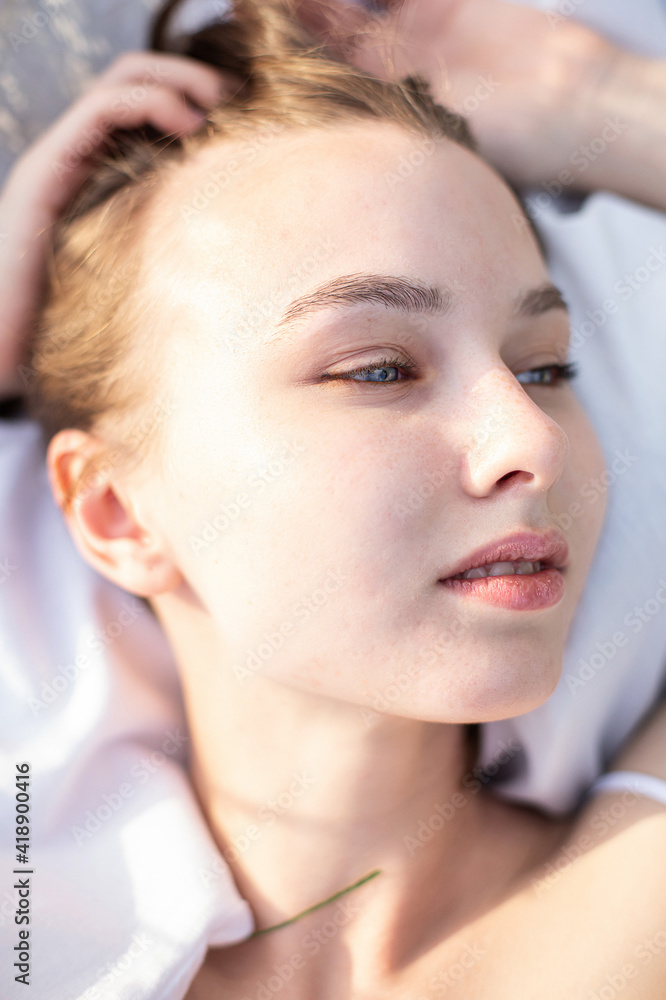 Fototapeta premium White girl with blonde hair on white