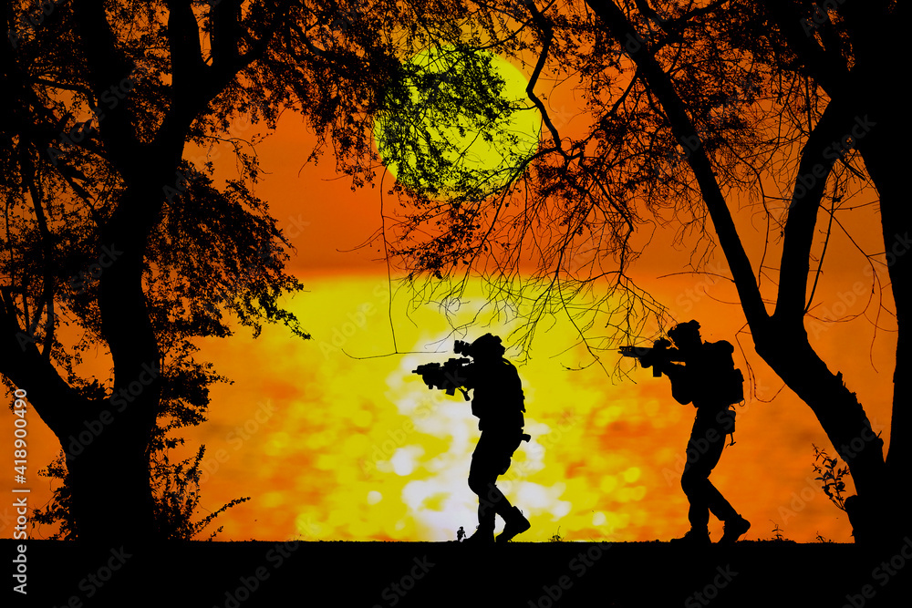 A black silhouette of an american soldier patrolling the sunset A black silhouette of an american soldier patrolling the sunset