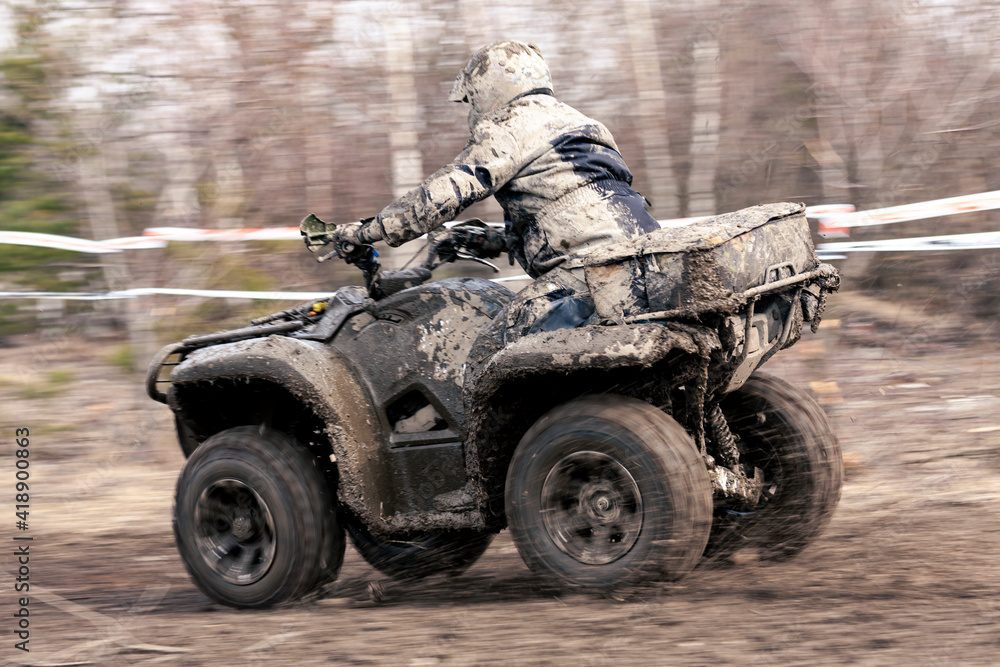 Fototapeta premium Quad competition. Dirty quad starting in a extreme competition. Dynamic shot of racer on quad motorbike in the race