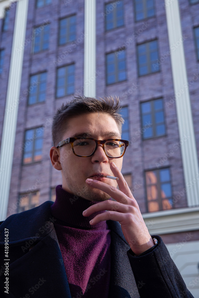 White european young man building behind White european young man building behind