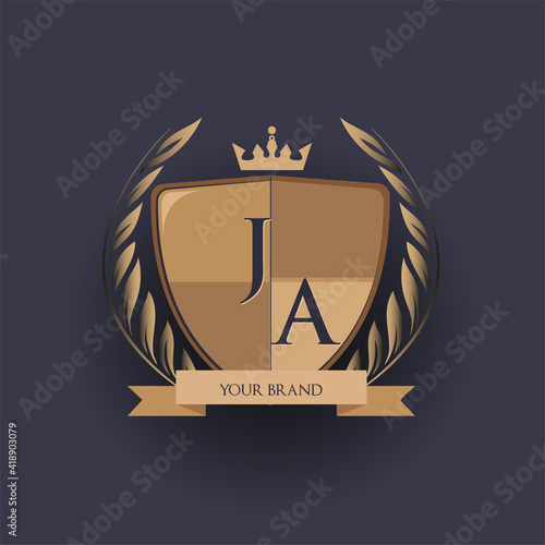 initial letter JA logotype colored brown and gold isolated with shield, crown and laurel design, logo for college and sport club. photo