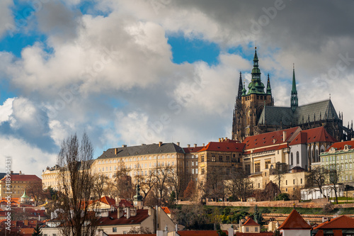 St. Vitus Cathedral and Prague Castle in golden sunlight on cloudy day