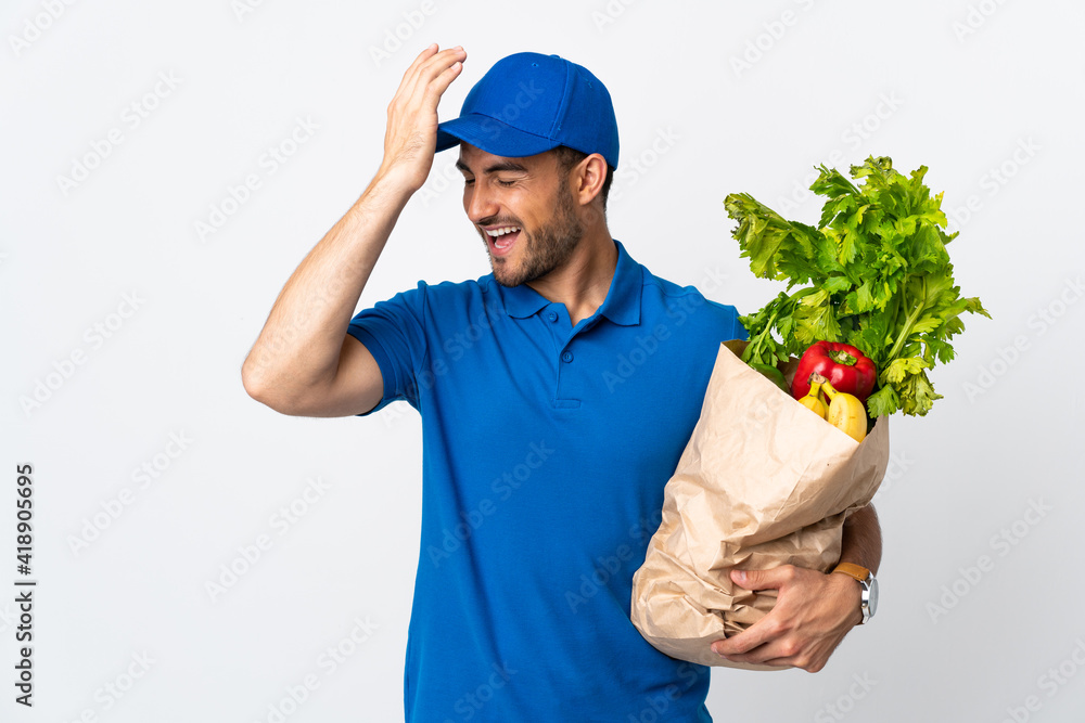 Delivery man with vegetables isolated on white background has realized something and intending the solution Delivery man with vegetables isolated on white background has realized something and intending the solution