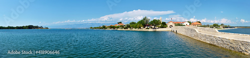 Panoramic image of Nin, historic medieval town in the Zadar County of Croatia. Panoramic image of bridge that leads to city center in lagoon on the Adriatic Sea.