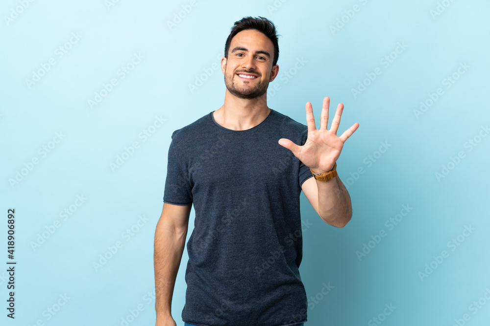 Young handsome man over isolated background counting five with fingers Young handsome man over isolated background counting five with fingers