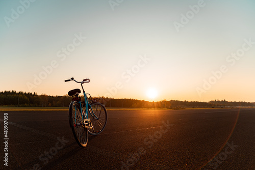 Bicycle on an airfield during a beautiful sunset