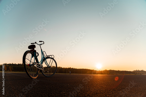 Bicycle on an airfield during a beautiful sunset