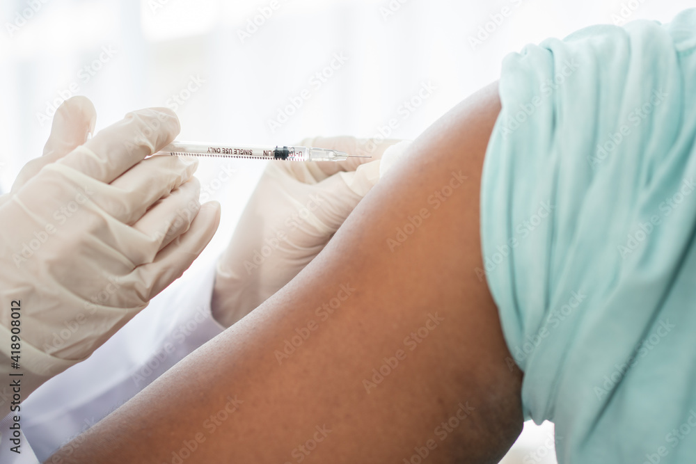 African American Wear a medical mask and being covid vaccinated for the prevention of coronavirus and flu. Concept of immunization from inoculation African American Wear a medical mask and being covid vaccinated for the prevention of coronavirus and flu. Concept of immunization from inoculation