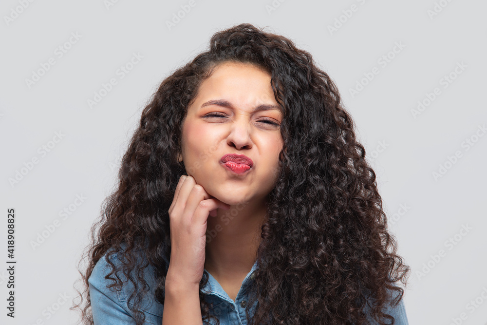 A CHEERFUL TEENAGER PLAYFULLY POSING IN FRONT OF CAMERA	