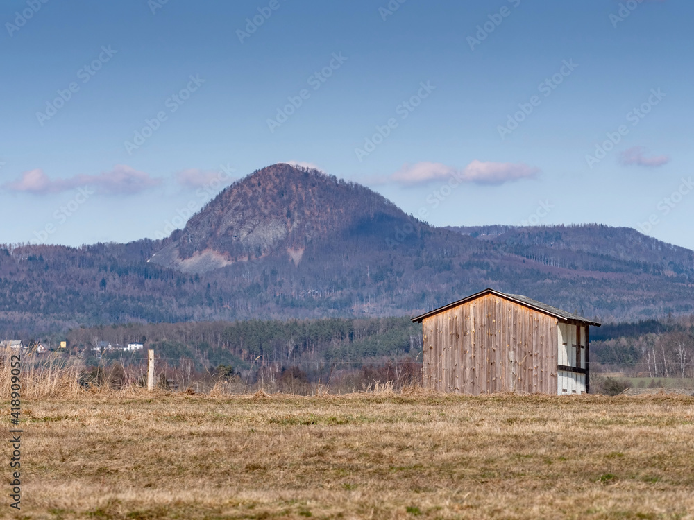 Hay hut in the pasture in front of the summits of the north Czech hills. Hay hut in the pasture in front of the summits of the north Czech hills.