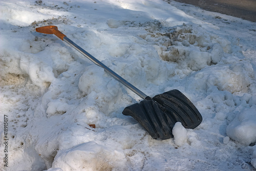 a snow shovel is lying on a snowdrift photo