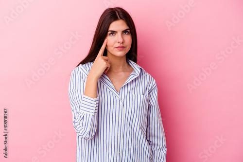 Young caucasian woman isolated on pink background crying, unhappy with something, agony and confusion concept. © Asier