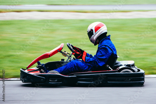 go-cart speeding along a race course . Motion blur in asphalt to emphasize speed.