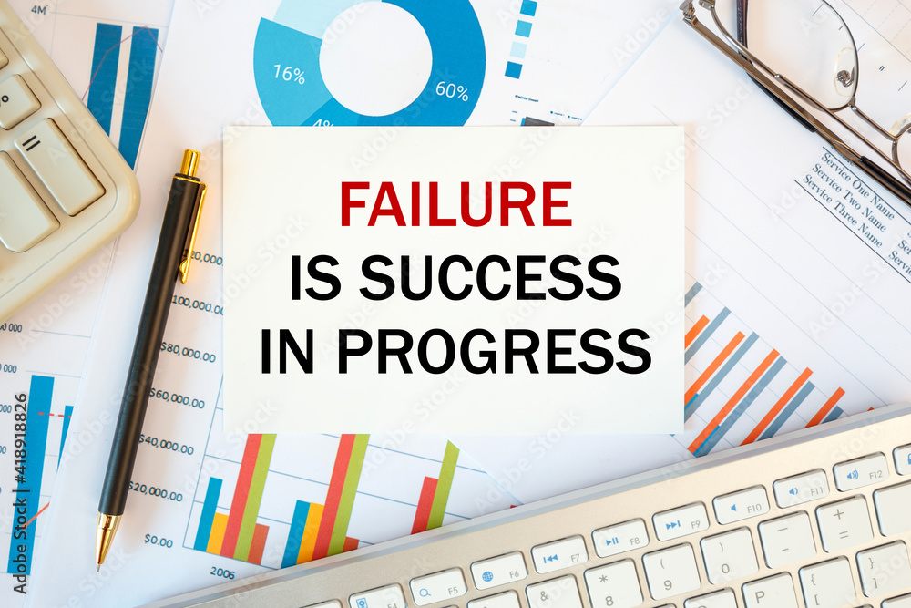 Failure Is Success In Progress is written in a document on the office desk, diagram and keyboard Failure Is Success In Progress is written in a document on the office desk, diagram and keyboard