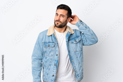 Young handsome man with beard isolated on white background having doubts