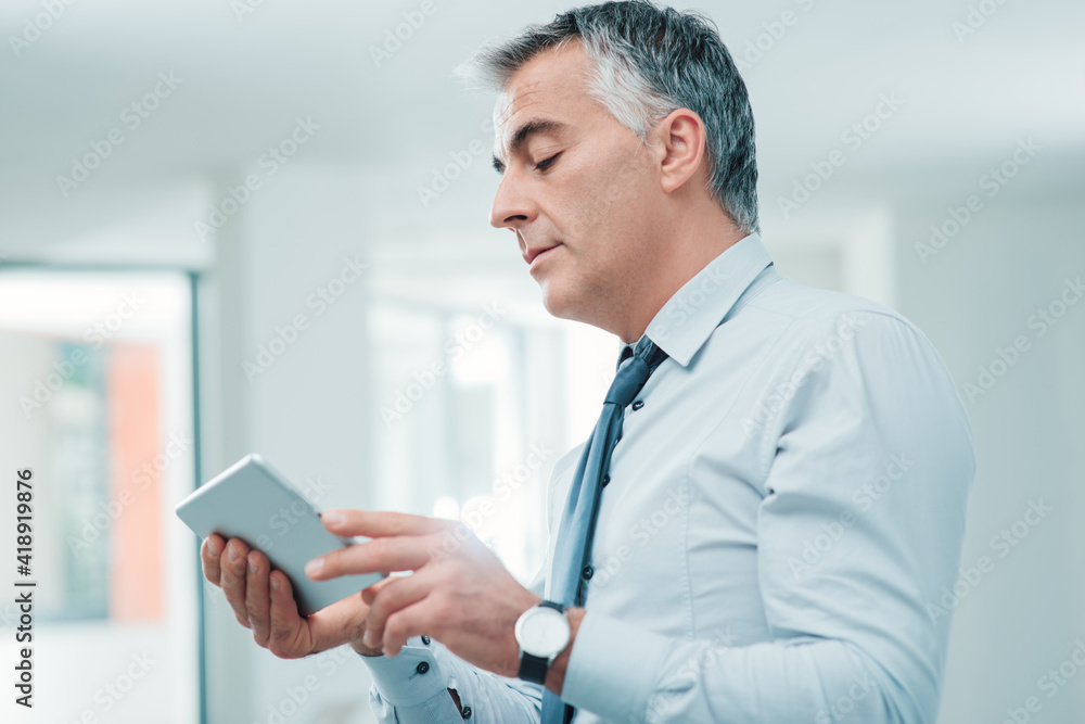 Confident executive using a touch screen tablet Confident executive using a touch screen tablet