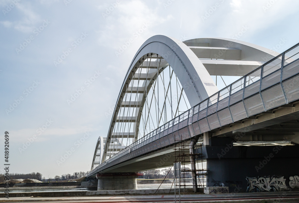 Novi Sad, Serbia - March 08. 2021: Zezelj bridge on river Danube in Novi Sad Serbia. The prospect of built New Zezelj Bridge viewed from the Petrovaradin side of the promenade.