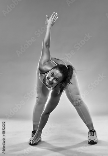 Fototapeta Naklejka Na Ścianę i Meble -  Curvy woman doing fitness exercises