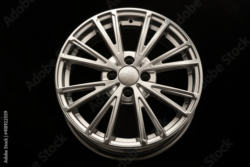 New modern alloy wheel close-up on a black background. Car beautiful