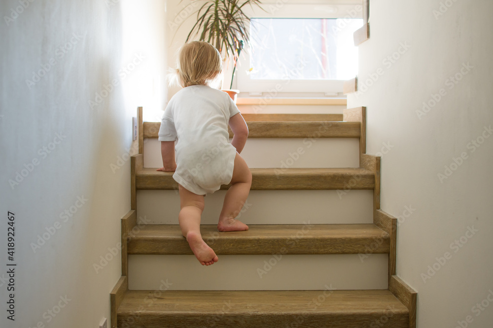 custom made wallpaper toronto digitalLittle caucasian toddler is crawling on stairs at home in sunny interior.  Child safety at home. Danger in your house concept.